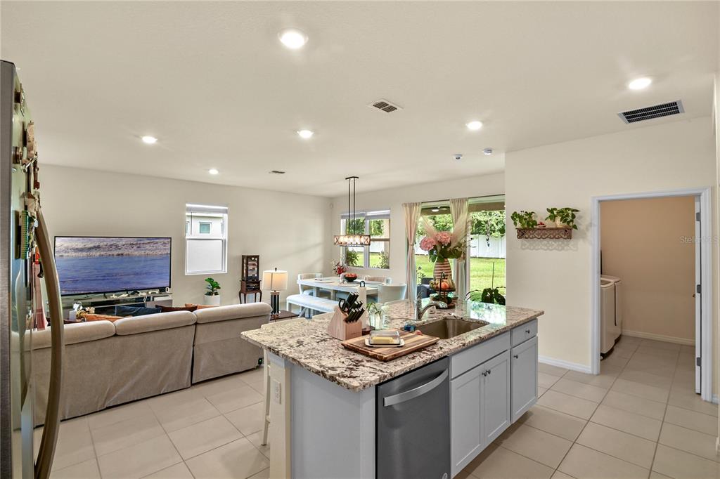 6345 Southwest 88th Loop Ocala, FL 34476 - Photo 17 of 41 a kitchen with stainless steel appliances kitchen island granite countertop a sink and cabinets