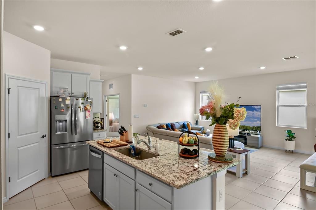 6345 Southwest 88th Loop Ocala, FL 34476 - Photo 19 of 41 a kitchen with stainless steel appliances granite countertop a sink stove and refrigerator