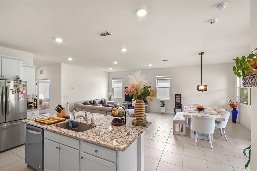 6345 Southwest 88th Loop Ocala, FL 34476 - Photo 20 of 41 a kitchen with a sink dining table and chairs