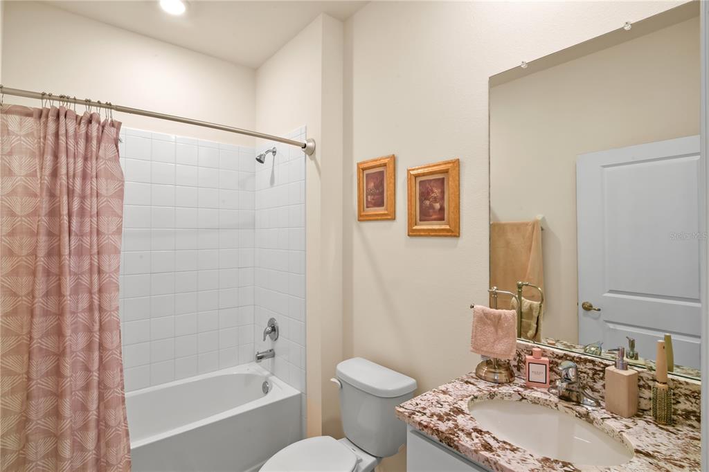 6345 Southwest 88th Loop Ocala, FL 34476 - Photo 27 of 41 a bathroom with a granite countertop sink toilet and shower