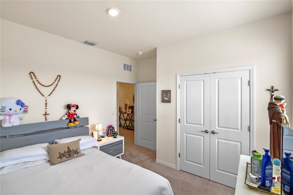 6345 Southwest 88th Loop Ocala, FL 34476 - Photo 29 of 41 a bedroom with a bed and a dresser