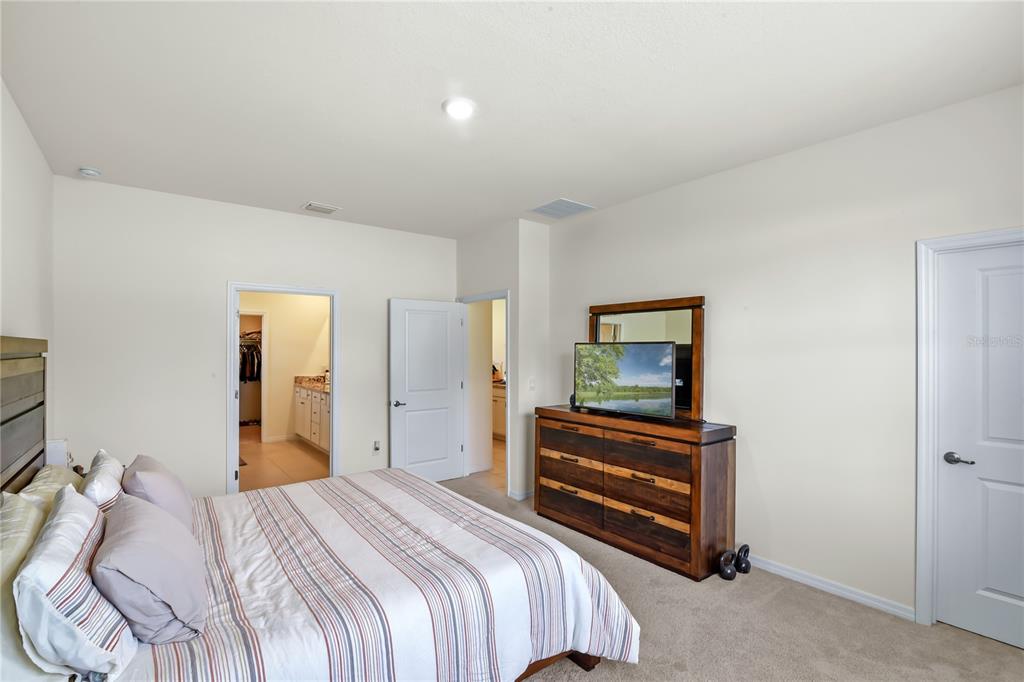 6345 Southwest 88th Loop Ocala, FL 34476 - Photo 32 of 41 a bedroom with a bed and a painting on the wall