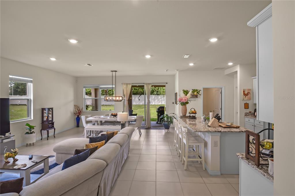 6345 Southwest 88th Loop Ocala, FL 34476 - Photo 9 of 41 a living room with furniture large window and flat screen tv