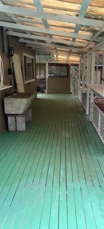 a view of a living room a wooden floor and an empty room