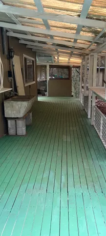 a view of a living room a wooden floor and an empty room