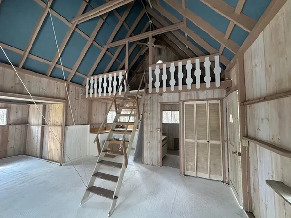 a view of a house with a yard and wooden fence