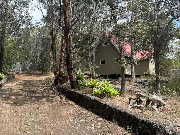 a view of a house with a yard and tree