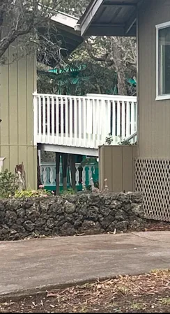 a view of a wooden house with a yard