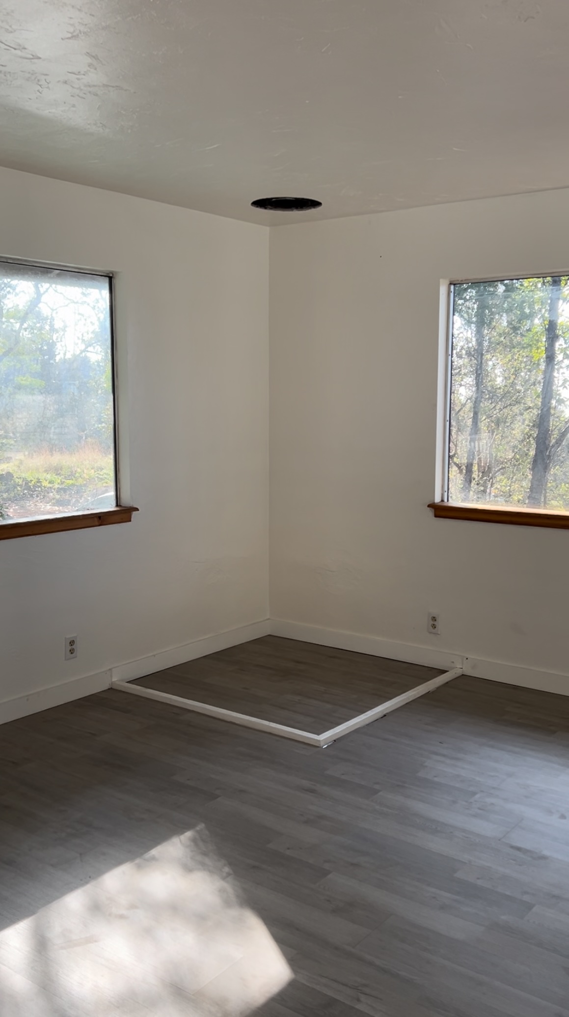 92-8845 Reef Parkway Ocean View, HI 96704 - Photo 9 of 23 an empty room with wooden floor and windows