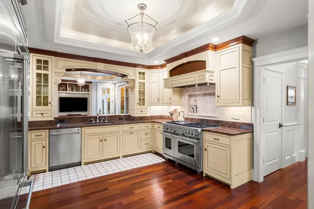 a kitchen with stainless steel appliances granite countertop a stove and a refrigerator