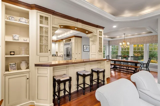 a kitchen with a table chairs stove and wooden floor