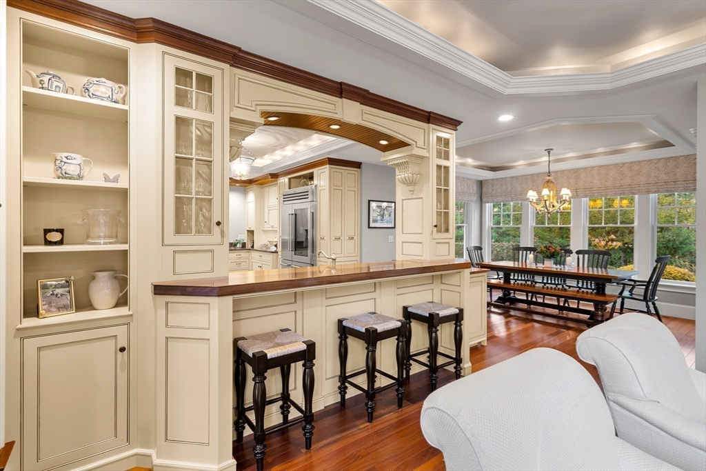 427 B Ipswich Road Boxford, MA 01921 - Photo 17 of 42 a kitchen with a table chairs stove and wooden floor