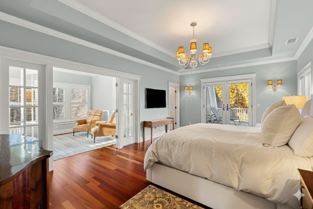 427 B Ipswich Road Boxford, MA 01921 - Photo 22 of 42 a spacious bedroom with a bed and a chandelier