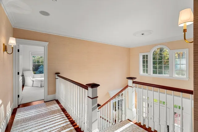 a view of a hallway with wooden floor and entryway