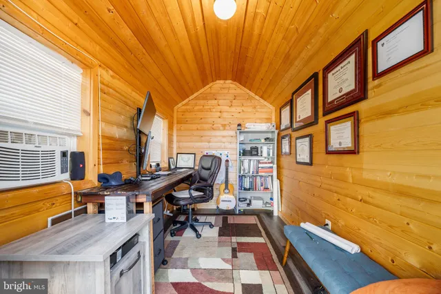 a view of a house with a deck and furniture