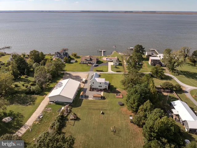 an aerial view of a house with yard swimming pool and outdoor seating