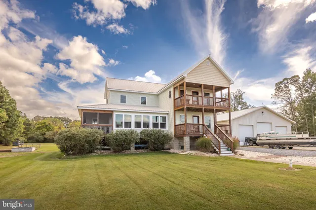 an aerial view of a house with a big yard