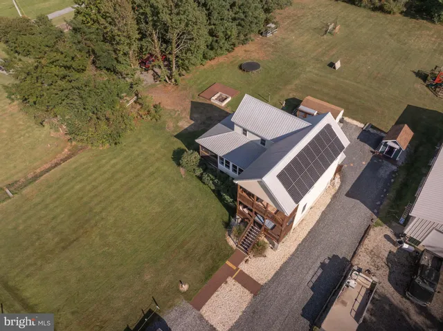 a view of a house with a yard and sitting area