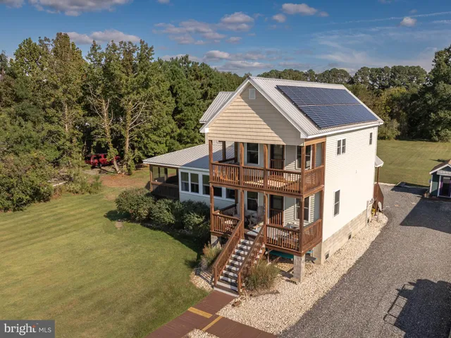 a front view of a house with yard and green space