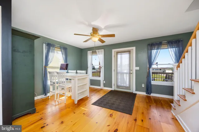 a living room with furniture a flat screen tv and a floor to ceiling window