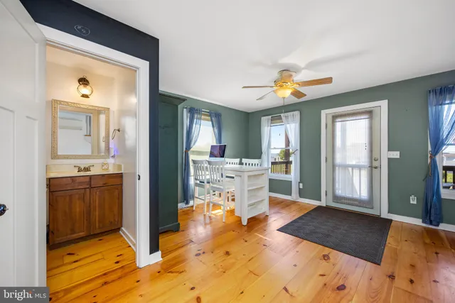 a living room with stainless steel appliances kitchen island granite countertop furniture and a fireplace