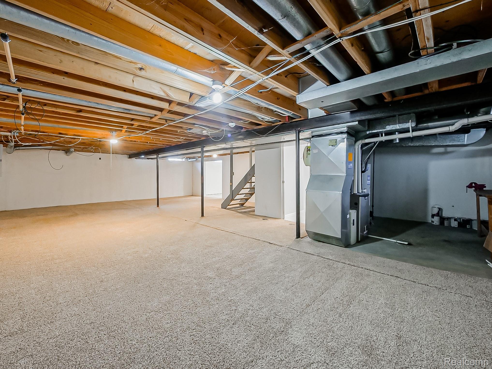 42195 Park Ridge Road Novi, MI 48375 - Photo 42 of 52 Expansive unfinished basement featuring exposed ceiling joists, concrete support posts, and an accessible utility unit