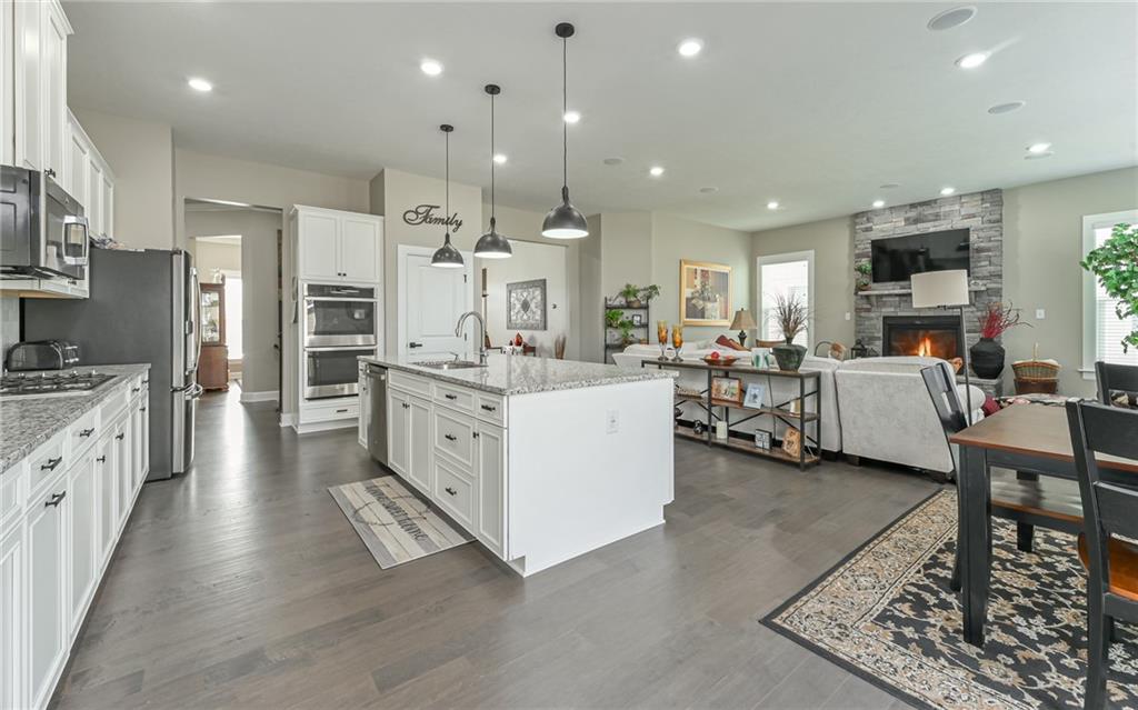 3044 Spruce Road Gibsonia, PA 15044 - Photo 7 of 25 a large white kitchen with stainless steel appliances kitchen island granite countertop a large center island and a sink