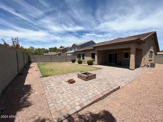 a view of a house with swimming pool and sitting area