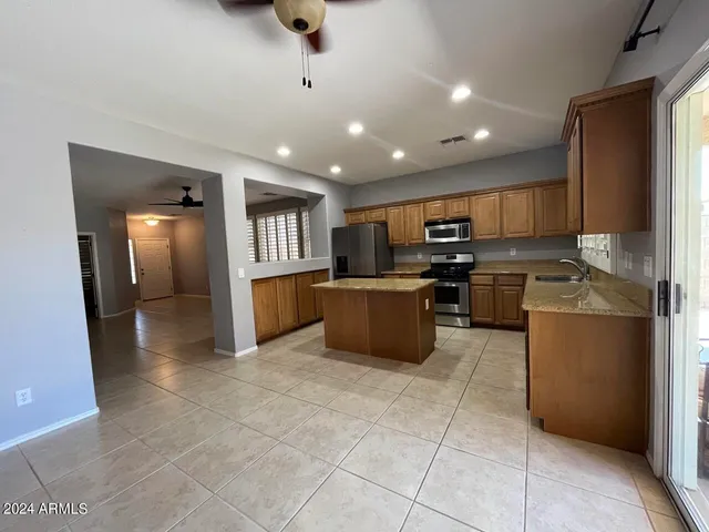 a large kitchen with cabinets and stainless steel appliances