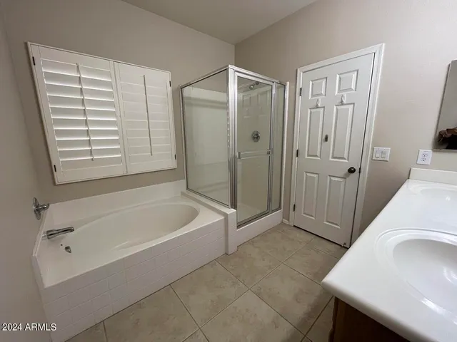 a bathroom with a tub a sink and a shower