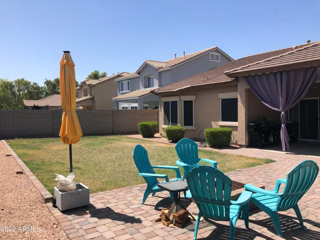 a view of a patio with table and chairs a barbeque with potted plants