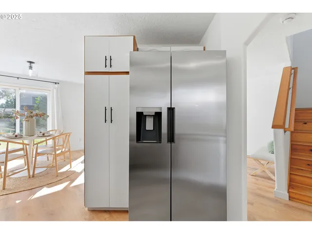 a bathroom with a refrigerator and a sink