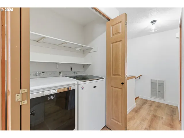 a view of a kitchen with refrigerator and cabinet