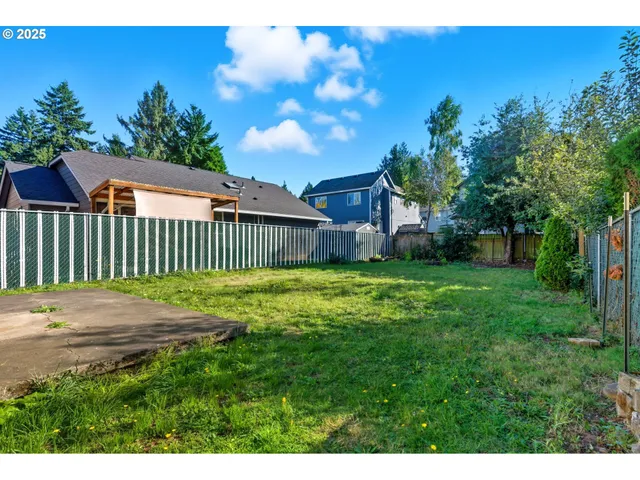 a view of backyard with a garden and deck