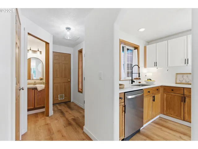 a kitchen with stainless steel appliances granite countertop a refrigerator and sink