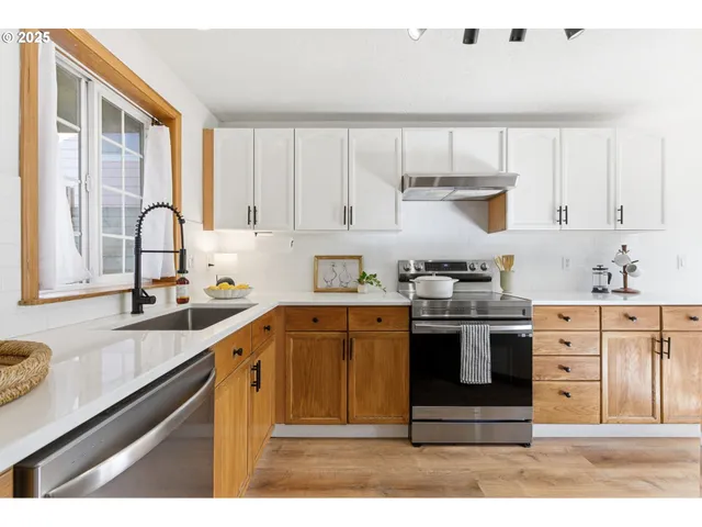 a kitchen with granite countertop a stove a sink and a granite counter tops