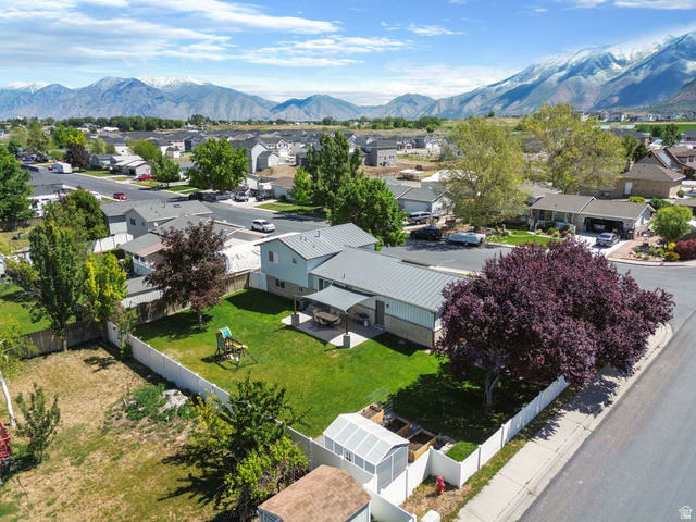 415 360 East Salem, UT 84653 - Photo 19 of 20 Expansive backyard featuring a manicured lawn, a covered patio, and a white privacy fence