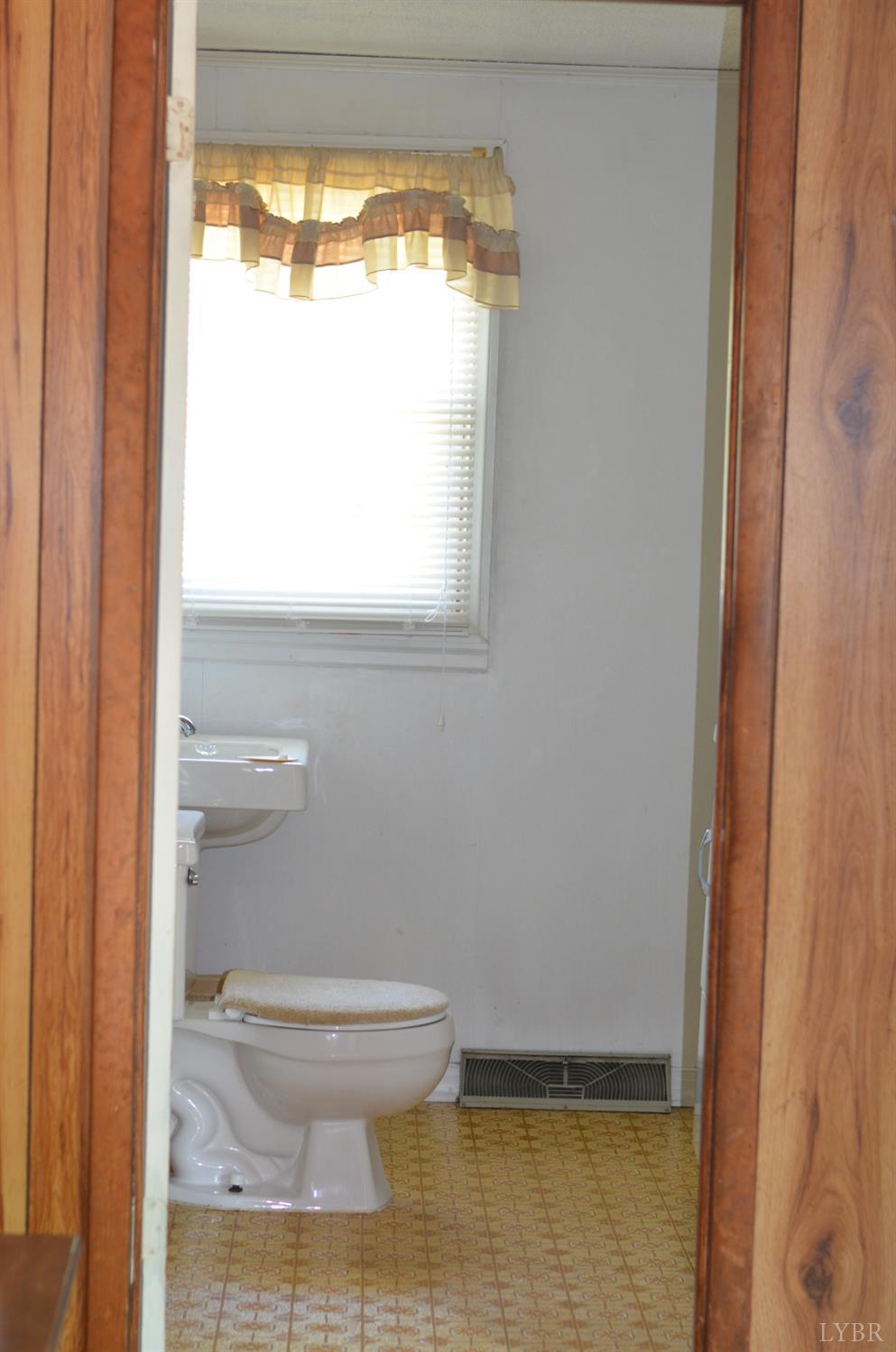 1953 Wards Road Hurt, VA 24563 - Photo 8 of 50 a bathroom with a toilet a window and a shower
