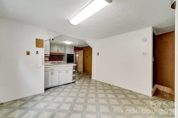 an empty room with windows and entrance