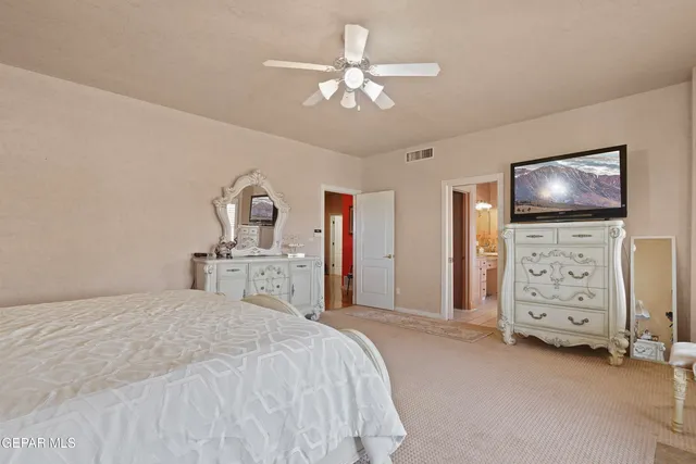 a bedroom with a bed and a tv