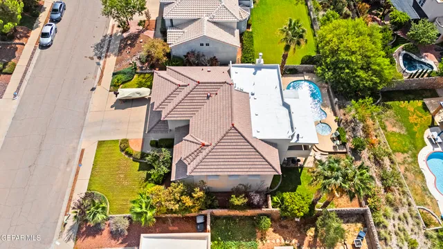 an aerial view of a house with a yard and potted plants