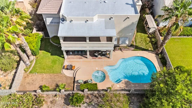 an aerial view of a house with a swimming pool