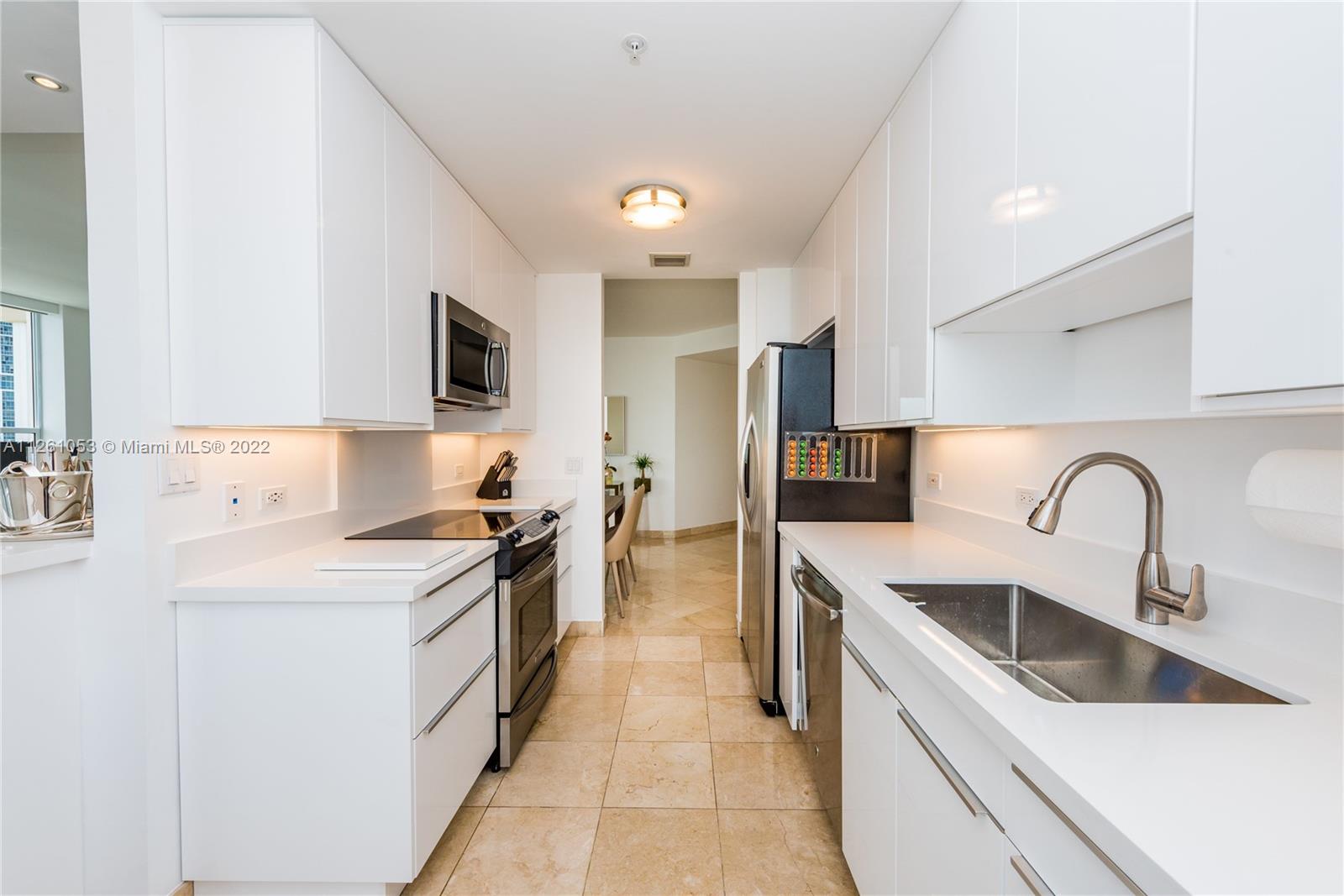 801 Brickell Key Boulevard, Unit 2401 Miami, FL 33131 - Photo 13 of 35 a kitchen with a sink stove top oven and refrigerator