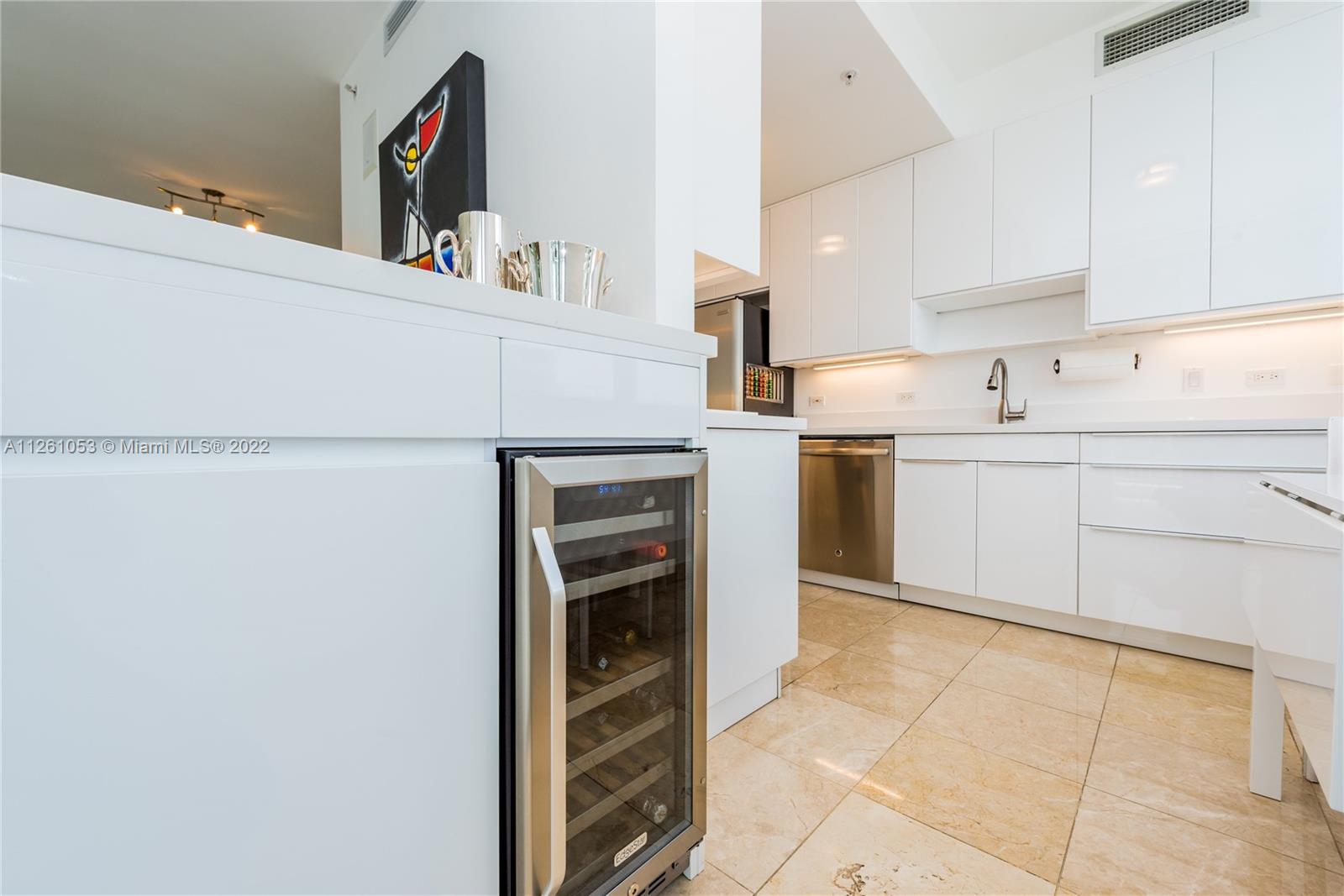 801 Brickell Key Boulevard, Unit 2401 Miami, FL 33131 - Photo 14 of 35 a kitchen with stainless steel appliances granite countertop a sink and cabinets