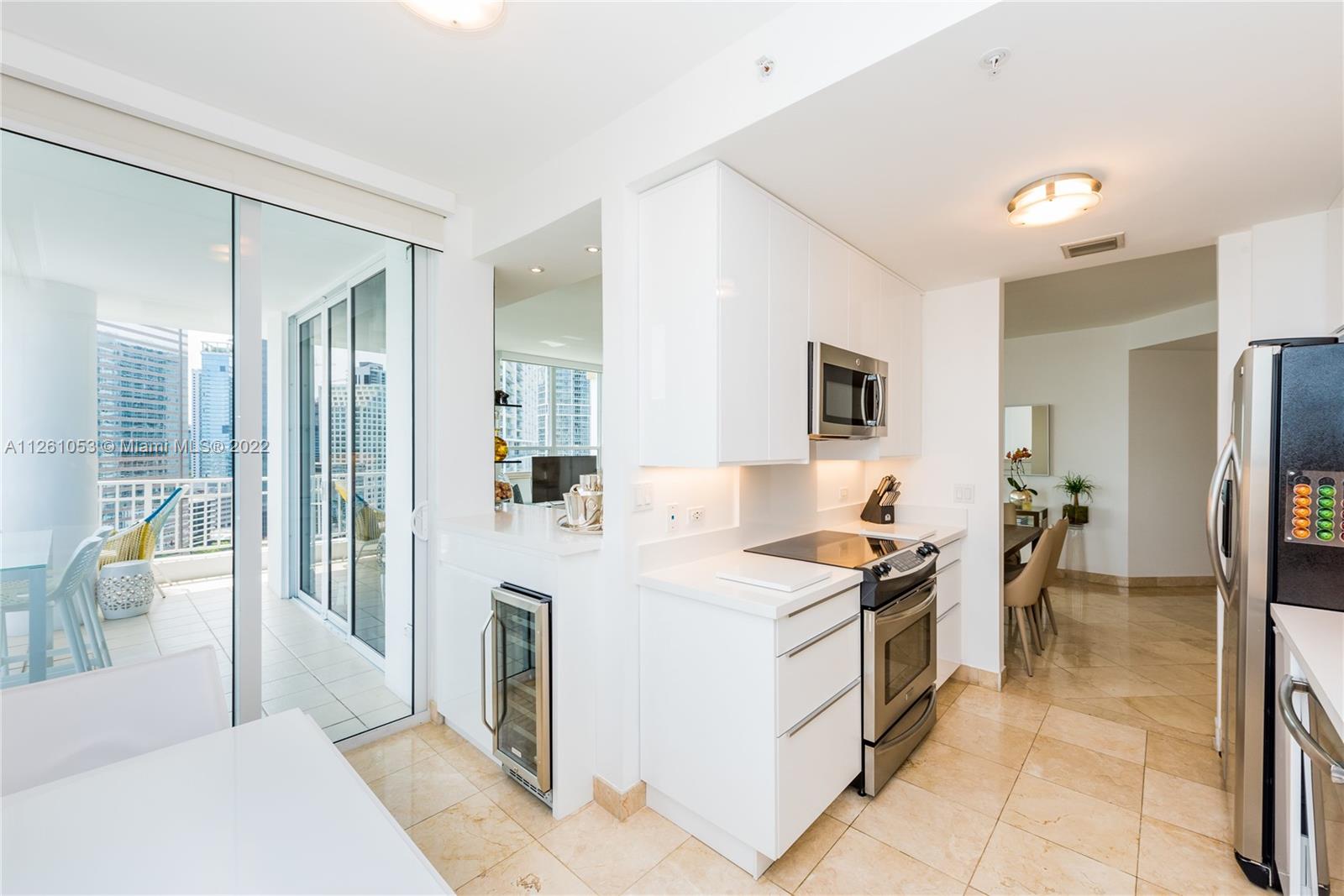 801 Brickell Key Boulevard, Unit 2401 Miami, FL 33131 - Photo 15 of 35 a kitchen with a sink stove and refrigerator