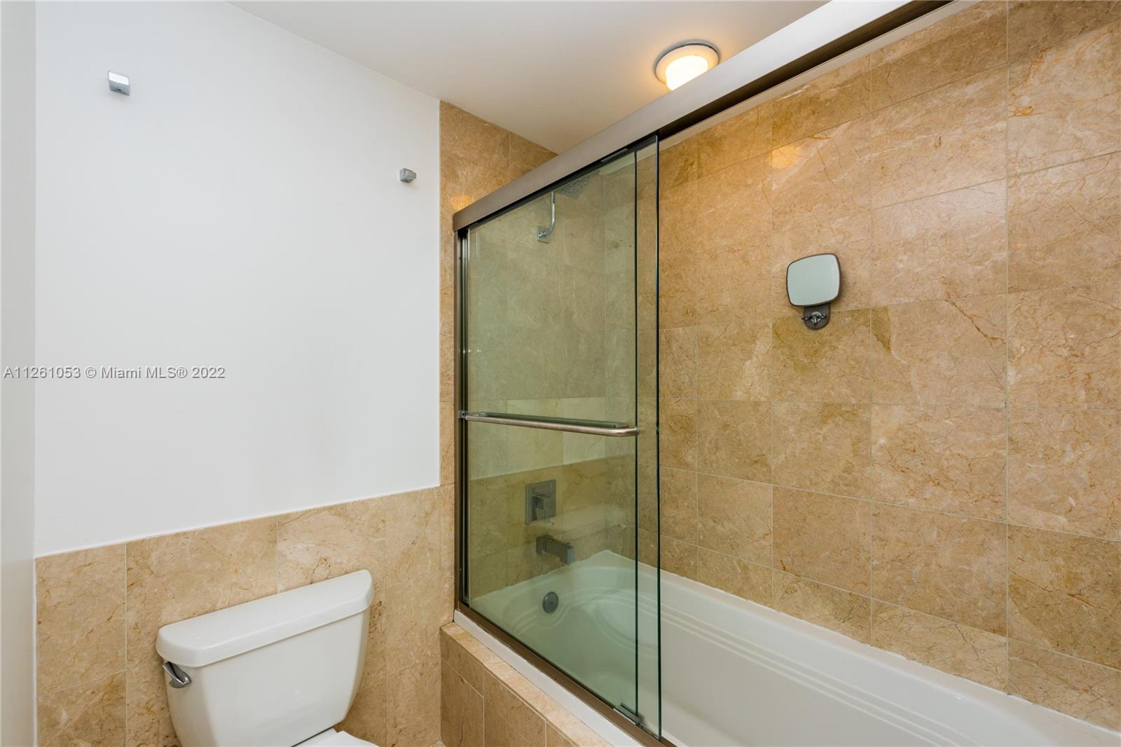 801 Brickell Key Boulevard, Unit 2401 Miami, FL 33131 - Photo 20 of 35 a bathroom with a shower and toilet