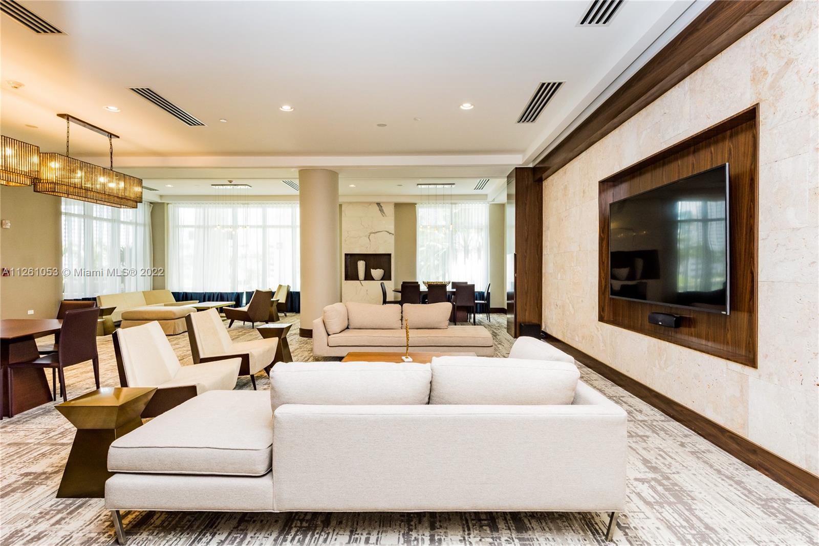 801 Brickell Key Boulevard, Unit 2401 Miami, FL 33131 - Photo 33 of 35 a living room with furniture and a flat screen tv