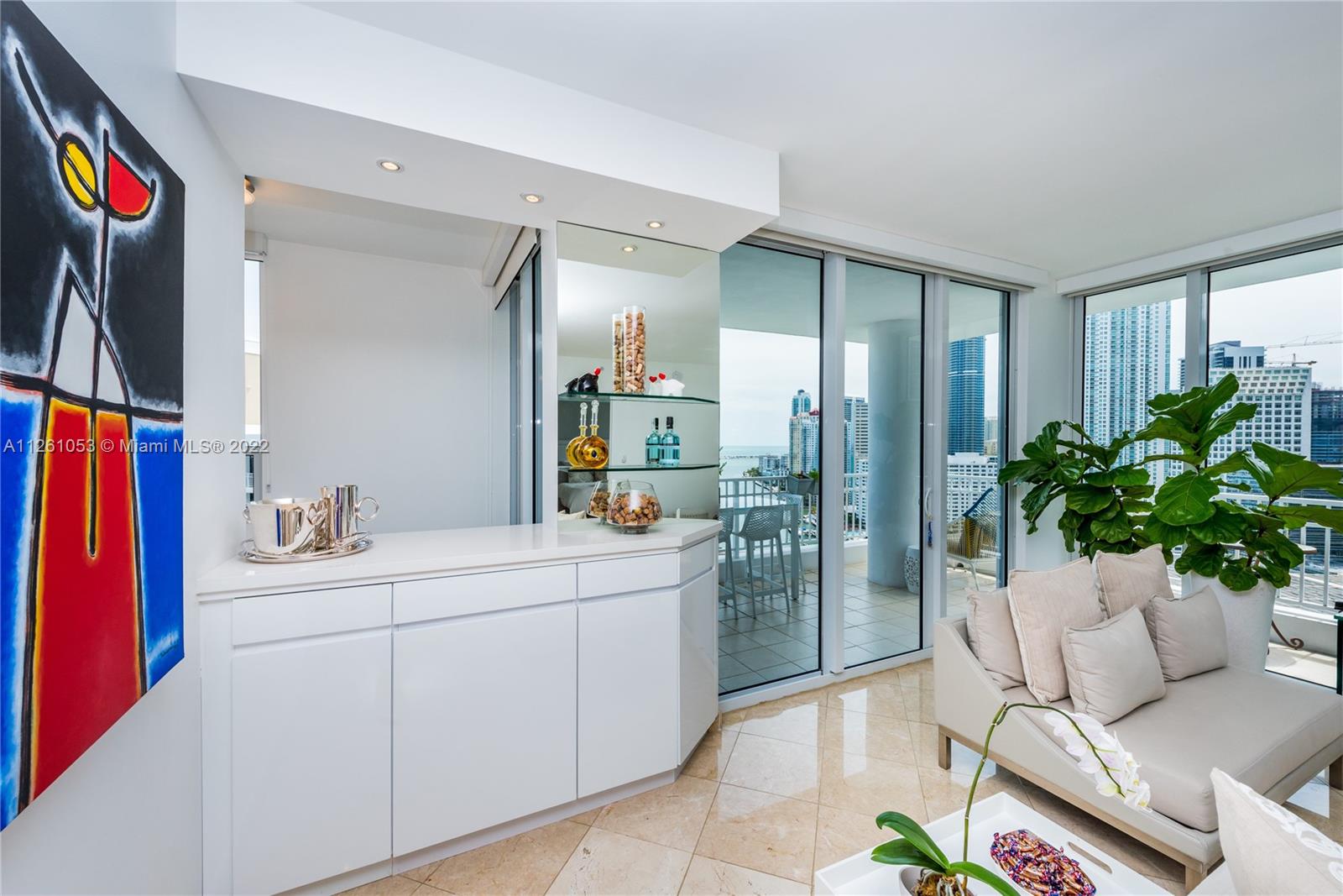 801 Brickell Key Boulevard, Unit 2401 Miami, FL 33131 - Photo 6 of 35 a living room with furniture and a potted plant