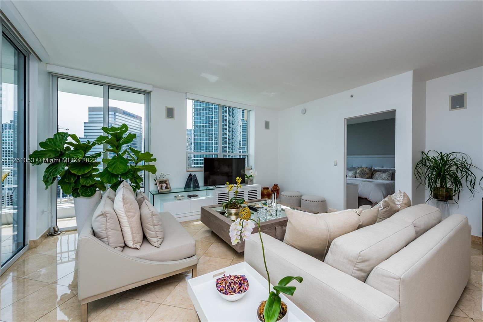 801 Brickell Key Boulevard, Unit 2401 Miami, FL 33131 - Photo 7 of 35 a living room with furniture and a potted plant