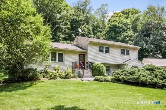 Spacious Ridgefield split-level offering over 2,400 sq ft of flexible living space with a wood-burning fireplace, multiple gathering areas, and a versatile lower level with private entrance-ideal for multigenerational living.